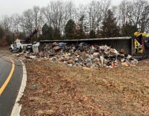 Overturned Tractor Trailer, with spilled contents on the roadway.